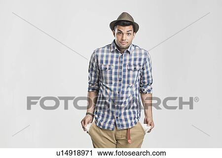 Man pulling at empty pockets View Large Photo Image Stock Image - Man pulling at empty pockets. Fotosearch