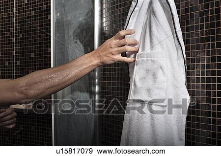 Stock Photo - Man reaching for bathrobe in shower. Fotosearch