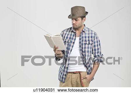 Man reading book with hand in pocket View Large Photo Image Stock Image - Man reading book with hand in pocket. Fotosearch