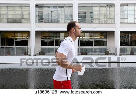 Man running on city street View Large Photo Image Stock Photo - Man running on city street. Fotosearch