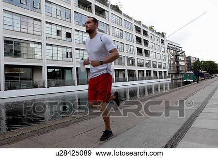 Stock Photo - Man running on city street. Fotosearch
