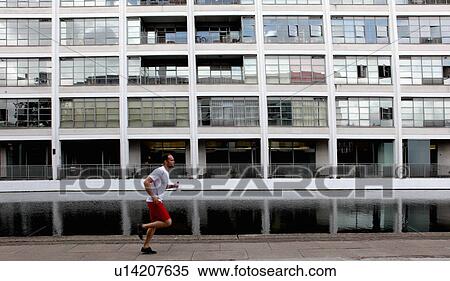 Man running on city street View Large Photo Image Stock Photography - Man running on city street. Fotosearch