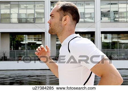 Stock Photography - Man running on city street. Fotosearch