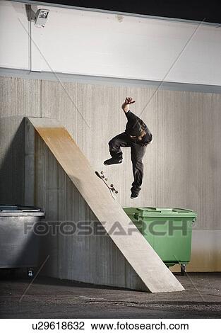 Man skating on urban ramp View Large Photo Image Stock Image - Man skating on urban ramp. Fotosearch
