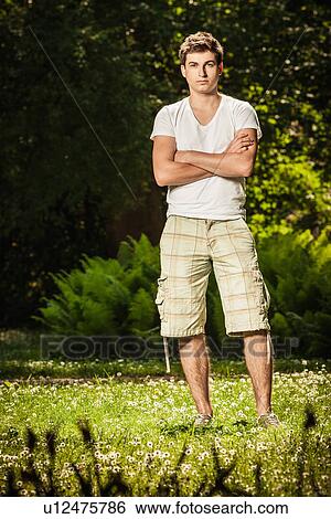 Man standing in field View Large Photo Image Stock Photograph - Man standing in field. Fotosearch