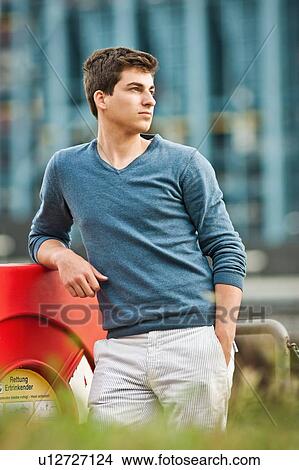 Picture - Man standing with hand in pocket. Fotosearch