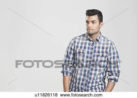 Man standing with hands in pockets View Large Photo Image Stock Photo - Man standing with hands in pockets. Fotosearch