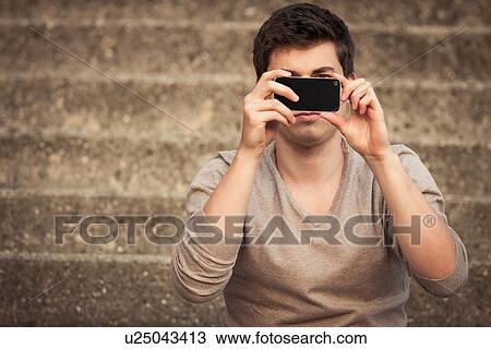 Man taking picture with cell phone View Large Photo Image Stock Image - Man taking picture with cell phone. Fotosearch