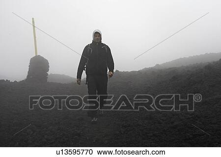 Man walking in rocky rural landscape View Large Photo Image Stock Image - Man walking in rocky rural landscape. Fotosearch