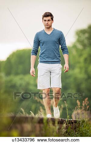 Man walking on train tracks View Large Photo Image Stock Photograph - Man walking on train tracks. Fotosearch