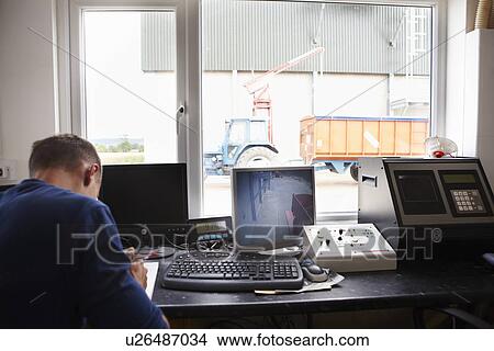 Picture - Man working in security station. Fotosearch