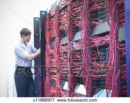 Stock Photo - Man working in server room. Fotosearch