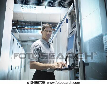 Stock Photo - Man working in server room. Fotosearch