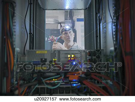 Stock Photo - Man working in server room. Fotosearch