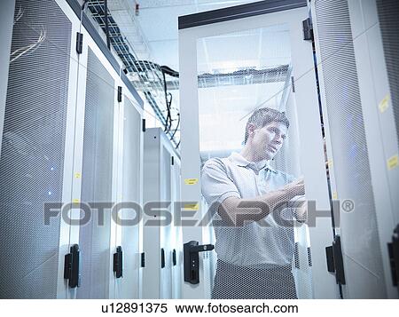 Stock Photography - Man working in server room. Fotosearch
