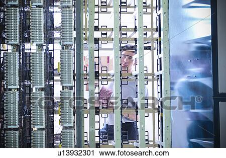 Man working in telephone exchange View Large Photo Image Stock Image - Man working in telephone exchange. Fotosearch