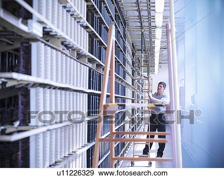 Man working in telephone exchange View Large Photo Image Stock Photo - Man working in telephone exchange. Fotosearch