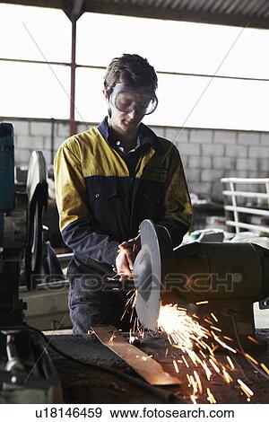 Metal worker using grinder in shop View Large Photo Image Stock Photo - Metal worker using grinder in shop. Fotosearch