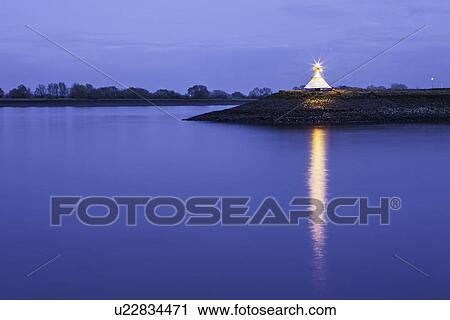 Monument by river lit up at night View Large Photo Image Stock Image - Monument by river lit up at night. Fotosearch