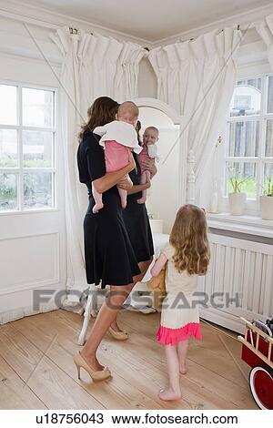 Mother and children in front of mirror View Large Photo Image Stock Image - Mother and children in front of mirror. Fotosearch