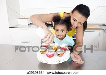 Mother and daughter baking together View Large Photo Image Picture - Mother and daughter baking together. Fotosearch