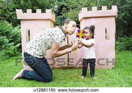 Mother and daughter blowing pinwheel View Large Photo Image Stock Photography - Mother and daughter blowing pinwheel. Fotosearch