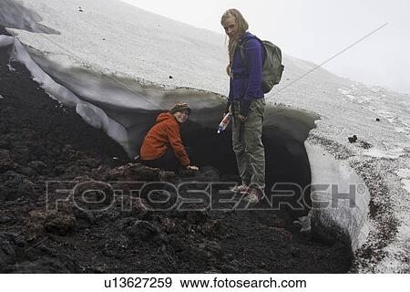 Mother and daughter exploring snow drift View Large Photo Image Stock Photo - Mother and daughter exploring snow drift. Fotosearch