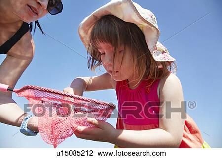 Mother and daughter fishing with net View Large Photo Image Stock Image - Mother and daughter fishing with net. Fotosearch