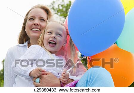 Mother and daughter holding balloons View Large Photo Image Stock Image - Mother and daughter holding balloons. Fotosearch