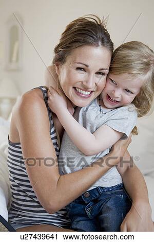 Mother and daughter hugging on bed View Large Photo Image Stock Image - Mother and daughter hugging on bed. Fotosearch