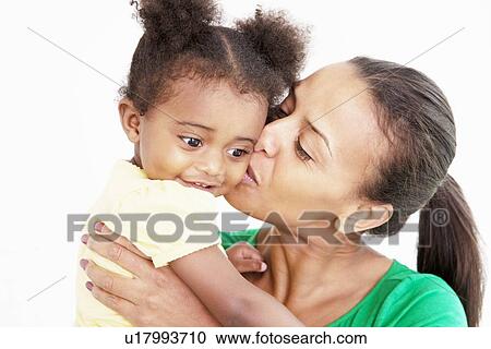 Mother and daughter kissing in kitchen View Large Photo Image Stock Image - Mother and daughter kissing in kitchen. Fotosearch