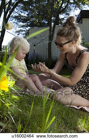 Picture - Mother and daughter playing outdoors. Fotosearch