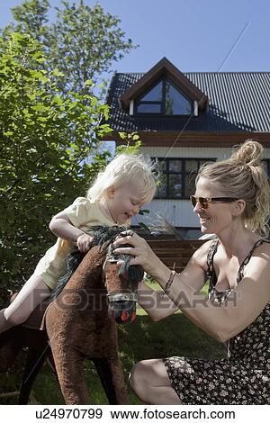 Mother and daughter playing outdoors View Large Photo Image Stock Photo - Mother and daughter playing outdoors. Fotosearch