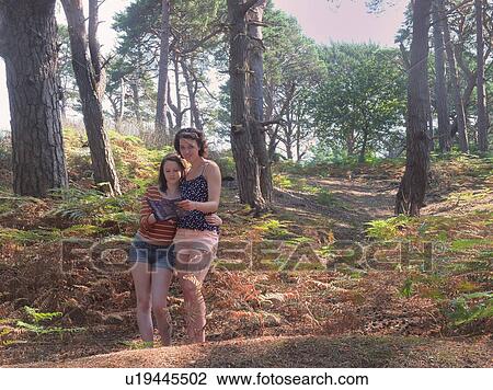 Mother and daughter reading forest map View Large Photo Image Stock Image - Mother and daughter reading forest map. Fotosearch