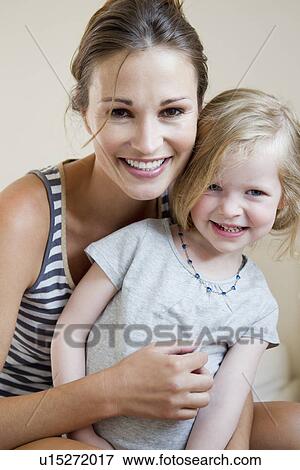 Stock Photo - Mother and daughter smiling together. Fotosearch