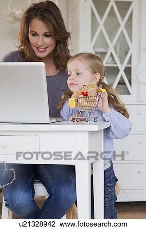 Mother and daughter using laptop View Large Photo Image Stock Image - Mother and daughter using laptop. Fotosearch