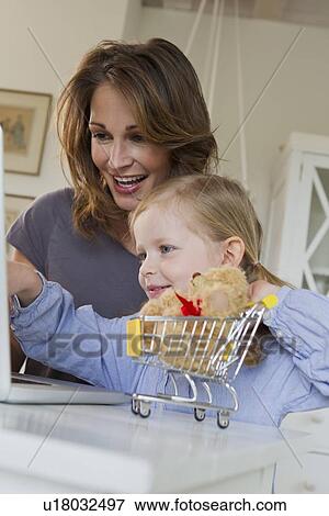 Mother and daughter using laptop View Large Photo Image Stock Photo - Mother and daughter using laptop. Fotosearch