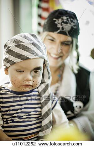 Stock Image - Mother and son wearing pirate costumes. Fotosearch
