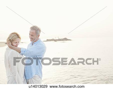 Older couple hugging on beach View Large Photo Image Stock Photo - Older couple hugging on beach. Fotosearch