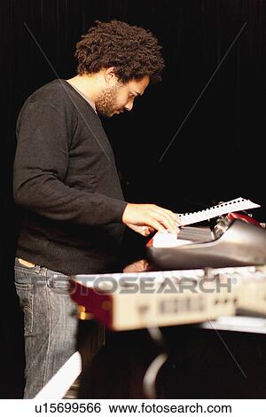 Piano player reading sheet music View Large Photo Image Stock Photograph - Piano player reading sheet music. Fotosearch