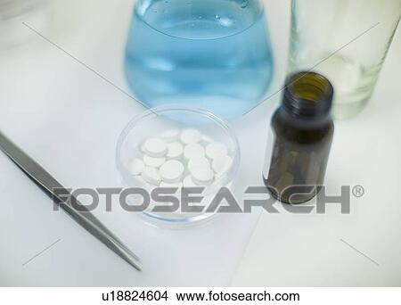 Pills, liquid and tweezers on tray View Large Photo Image Picture - Pills, liquid and tweezers on tray. Fotosearch