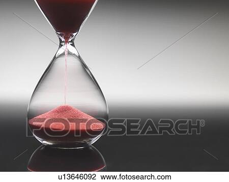Pink sand pouring through hourglass View Large Photo Image Stock Image - Pink sand pouring through hourglass. Fotosearch