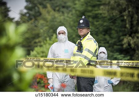 Picture - Policeman guarding forensic crime scene. Fotosearch