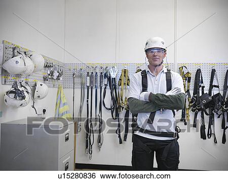 Portrait of car worker wearing health and safety equipment in car factory View Large Photo Image Stock Photograph - Portrait of car worker wearing health and safety equipment in car factory. Fotosearch