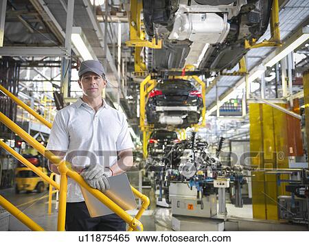Stock Photography - Portrait of worker in car factory. Fotosearch