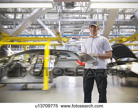 Portrait of worker with cars on production line in car factory View Large Photo Image Stock Photography - Portrait of worker with cars on production line in car factory. Fotosearch