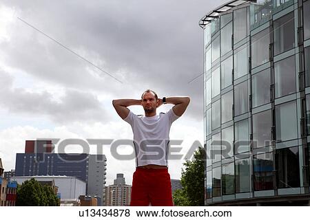 Runner stretching on city street View Large Photo Image Stock Photo - Runner stretching on city street. Fotosearch