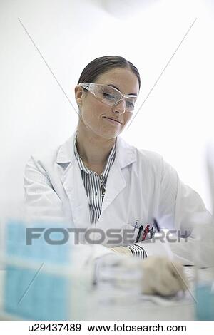 Stock Photo - Scientist working in lab. Fotosearch