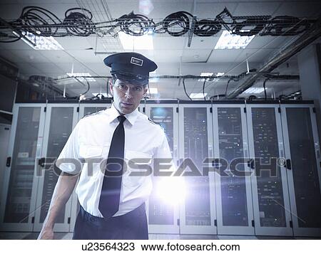 Security guard standing in server room View Large Photo Image Stock Image - Security guard standing in server room. Fotosearch