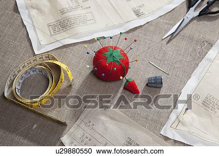 Sewing pattern, pin cushion and tape View Large Photo Image Stock Image - Sewing pattern, pin cushion and tape. Fotosearch
